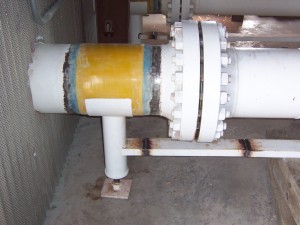 A pipe support installed next to a flange